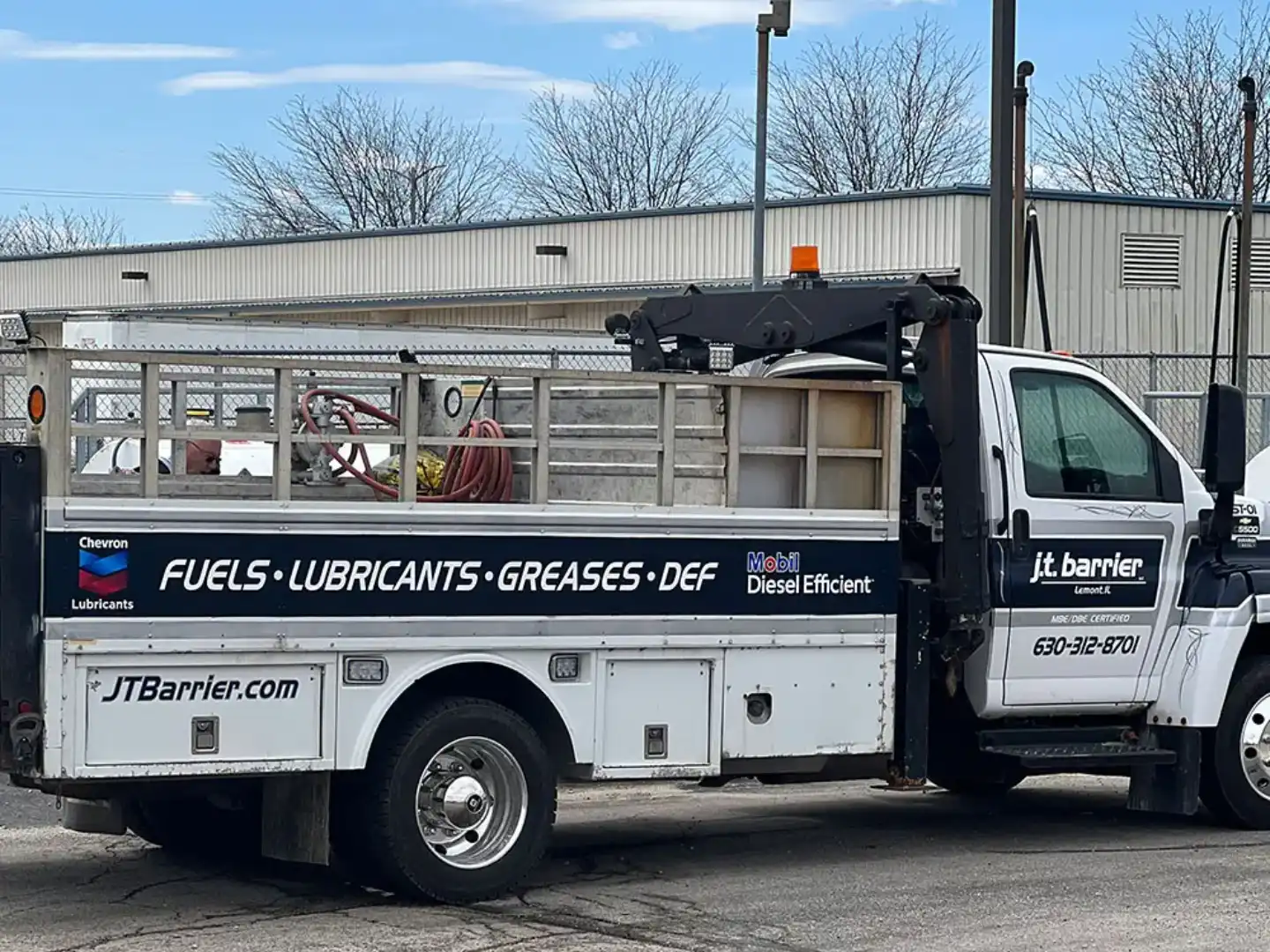 A white truck parked in front of a building.