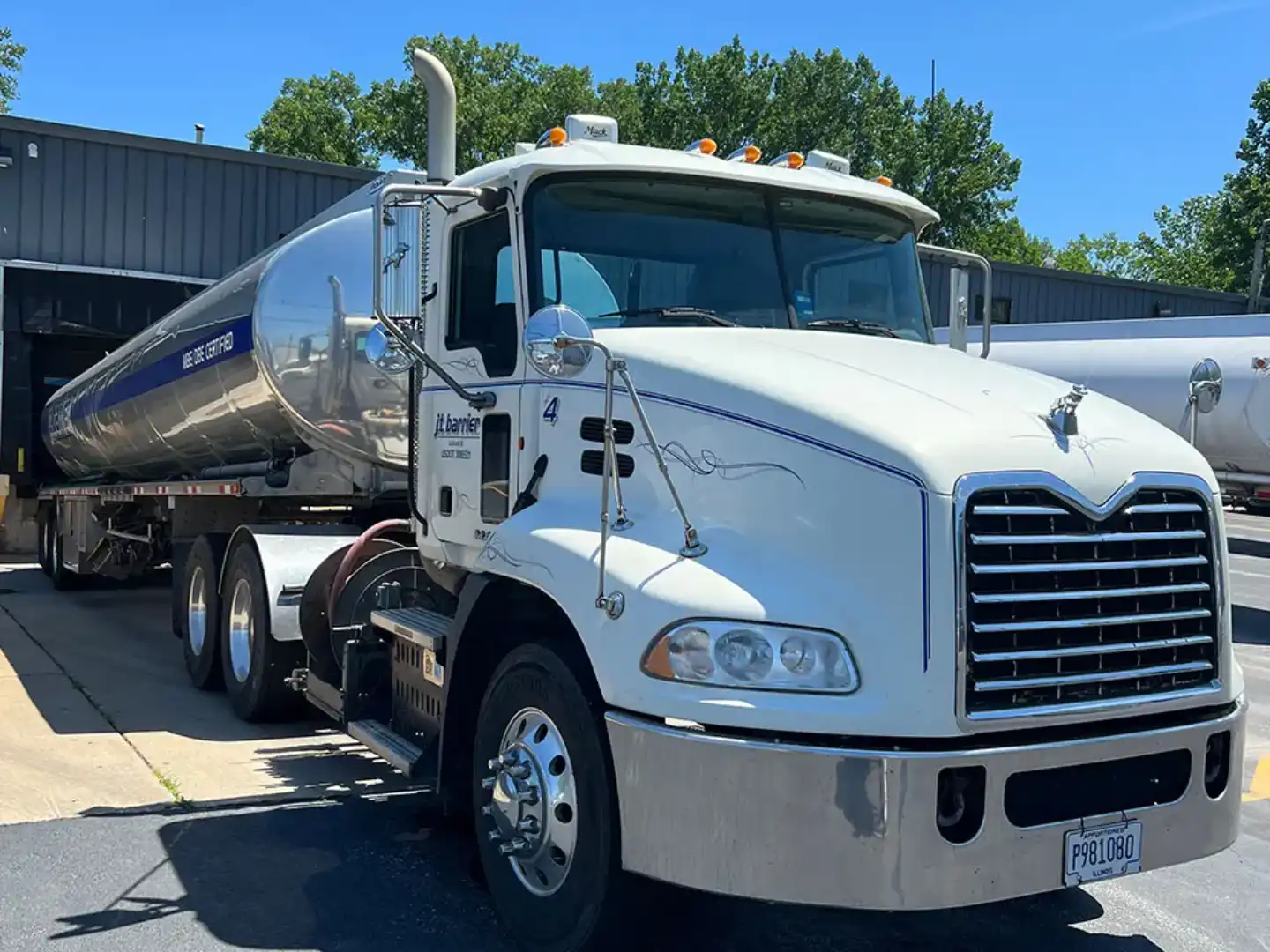 A white semi truck parked in front of a building.