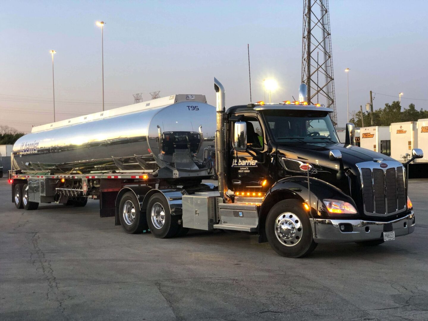 A large truck with a large tank parked in a parking lot.