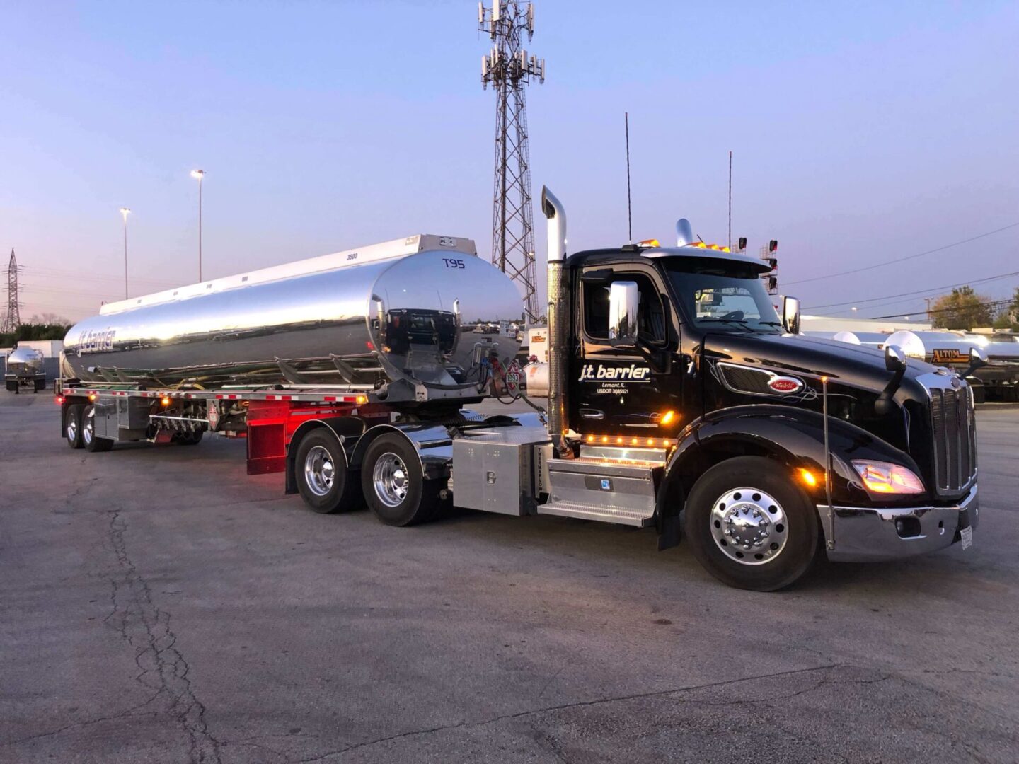 A large truck with a large tank sitting in a parking lot.