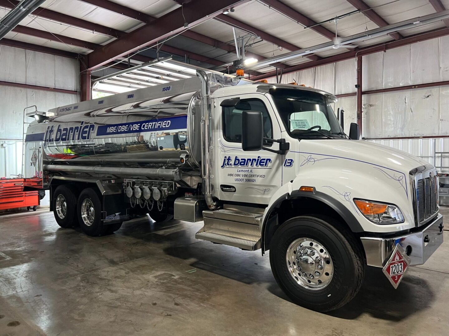 A large white truck parked in a warehouse.